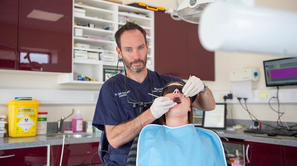 Dentist Dr Tom Rodgers pictured with a patient in his practice in Blackrock, Co Louth. Photograph: Ciara Wilkinson