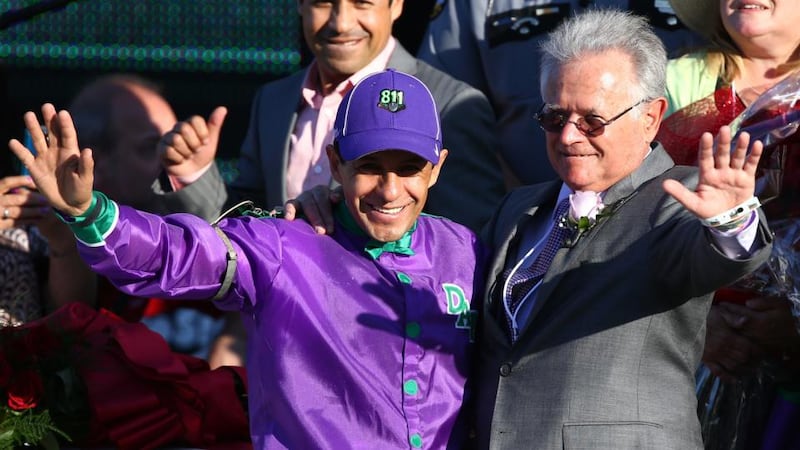 Jockey Victor Espinoza (left) and trainer Art Sherman (right) celebrate in the winners circle after guiding California Chrome to victory in the 140th Kentucky Derby at Churchill Downs in Louisville, Kentucky. Photograph: Andy Lyons/Getty Images