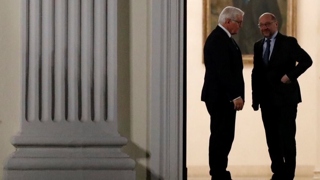 The leader of the Social Democrats, Martin Schulz (right) arrives for talks with chancellor Angela Merkel, hosted by German president Frank-Walter Steinmeier, on left. Photograph: Axel Schmidt/Reuters