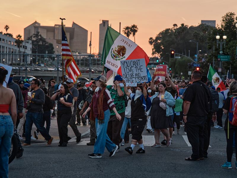 Protesters carry the flags of the United States and Mexico as they march in downtown Los Angeles on Tuesday evening. Photograph: Philip Cheung/New York Times