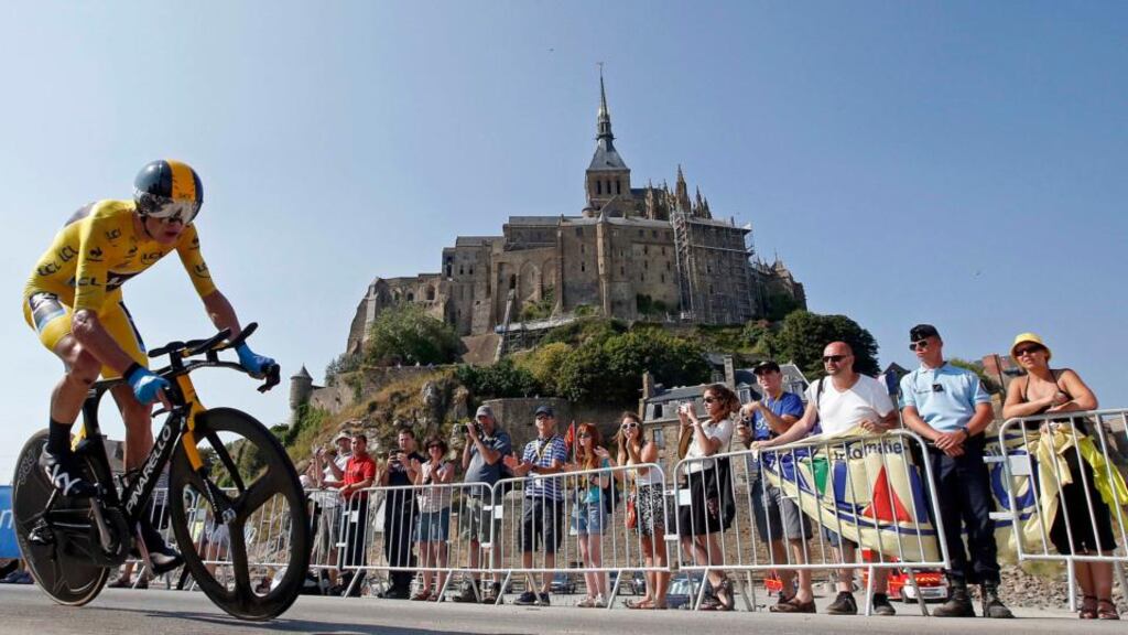 Team Sky rider yellow jersey holder Christopher Froome   cycles past  Mont Saint-Michel during the 32 km individual time trial eleventh stage of the centenary Tour de France. Photograph: Eric Gaillard/Reuters