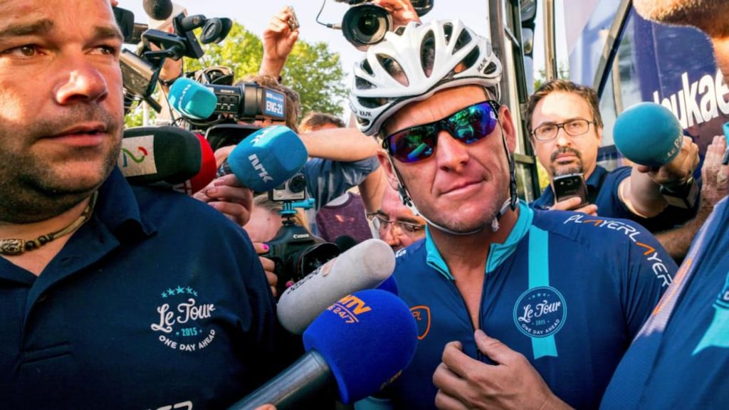 Cyclist Lance Armstrong of the U.S. speaks to journalists before taking part in Geoff Thomas’s ‘One Day Ahead’ charity event during a stage of the 102nd Tour de France cycling race from Muret to Rodez, France. Photo: Fred Lancelot/Reuters