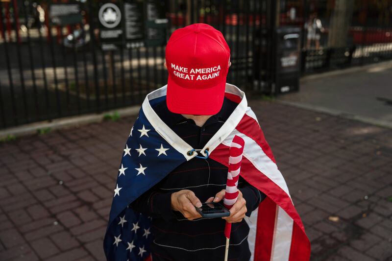 A supporter of former President Donald Trump checks her smartphone near Manhattan Criminal Court on Tuesday. Photograph: Adam Gray/New York Times