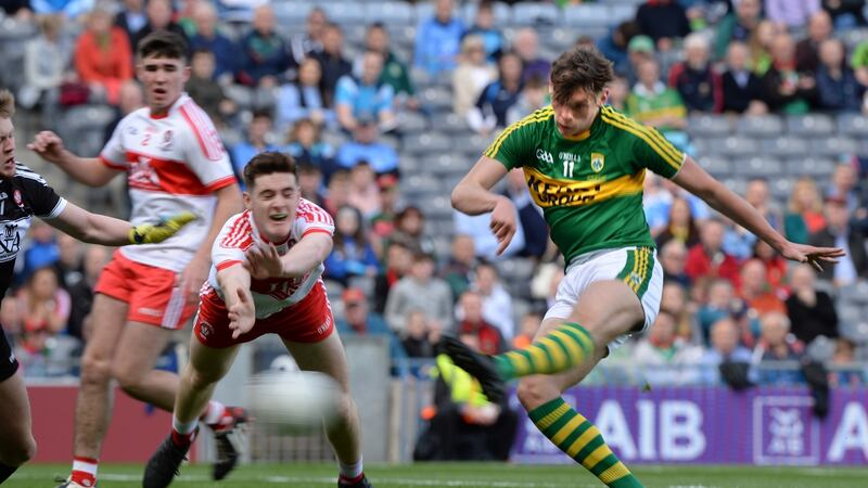 Kerry’s David Clifford scores a goal despite effort of Derry’s Pádraig McGrogan. Photograph: Dara Mac Donaill