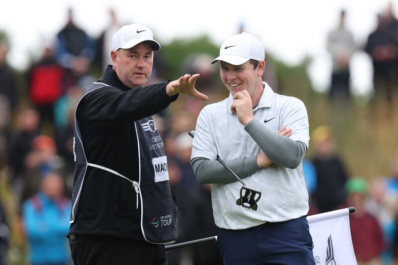 Robert MacIntyre of Scotland laughs alongside his caddie, Michael Burrow on the 17th green during the third round of the Scottish Open. Photograph: Harry How/Getty Images
