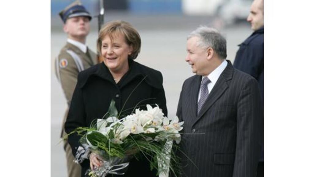 German chancellor Angela Merkel is welcomed by Polish prime
minister Jaroslaw Kaczynski at Warsaw military airport yesterday.
Dr Merkel was in Poland to sound out Polish reservations on the EU
constitution. Photograph: Peter Andrews/Reuters