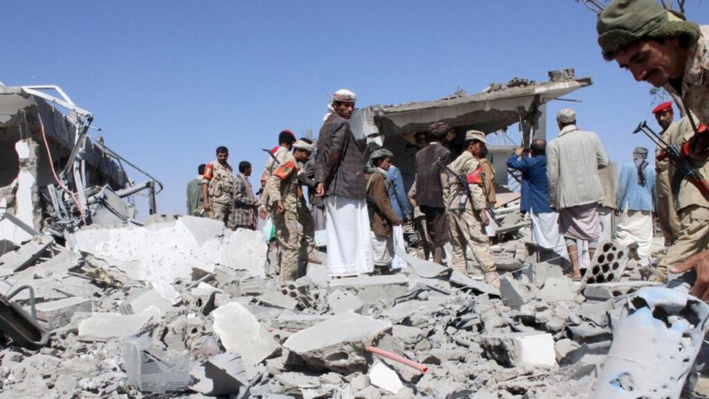 Soldiers and Houthi fighters inspect the damage caused by air strikes on the airport of Yemen’s northwestern city of Saada, a Houthi stronghold near the Saudi border, on Monday. Fighter jets attacked the Yemeni capital of Sanaa, residents said. Photograph: Reuters