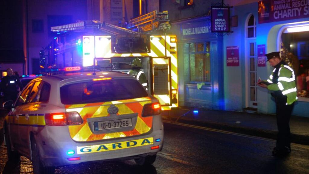 Garda and the fire service at the scene of the petrol bomb attack on Fine Gael TD Michelle Mulherin’s constituency office on John Street in Ballina on Tuesday night. Photograph: Henry Wills.