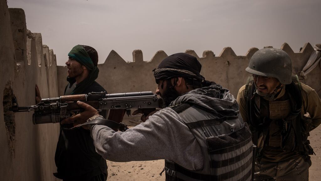 Members of Afghan forces on a house roof in Lashkar Gah, Afghanistanin May. File Photograph: Jim Huylebroek/The New York Times