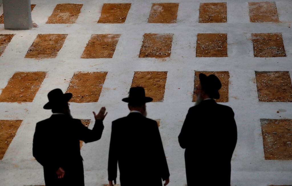 Jewish men walking in the Jewish underground cemetery of Givat Shaul in Jerusalem. Photograph: Ahmed Gharabli/AFP