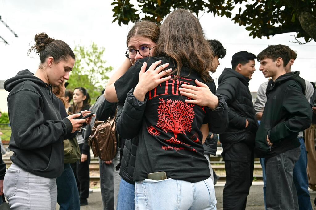 Students cry and embrace at the Notre-Dame de Toutes-Aides high school in Nantes, western France, after a knife attack left one student dead and three others wounded. Photograph: Loic Venance/Getty