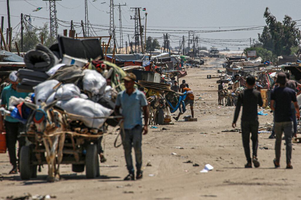 An Israeli tank in the background as displaced Palestinians evacuate the Shakush area on the northwestern outskirts of Rafah, in the southern Gaza Strip. Photograph: Bashar Taleb/AFP via Getty Images
