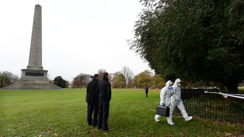 Members of the Gardai Technical Bureau Crime Scene Investigations unit arrive at the scene in the Phoenix Park, by the Wellington Monument, where the body of a man was found burned in a sleeping bag in the early hours of this morning. Photograph: Alan Betson/The Irish Times