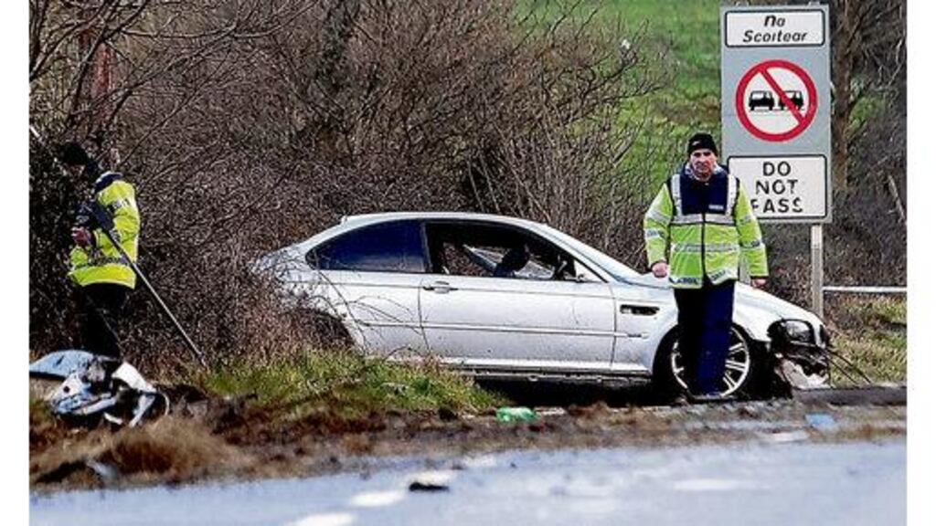 Gardaí at the scene of the single vehicle crash on the N9 Carlow to Kilkenny road near the village of Clara yesterday. Three men in their 20s were in the car when it left the road.