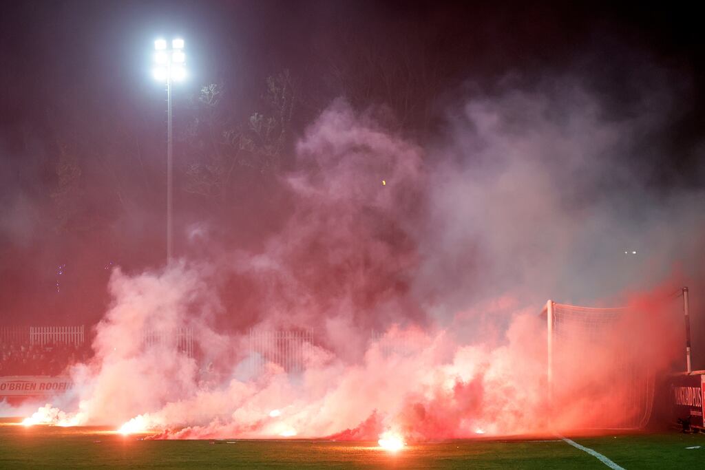 Fans throw flares onto the pitch at the beginning of the second half of the game between St Patrick's Athletic and Bohemians at Richmond Park, Dublin, on February 23th. Photograph: Laszlo Geczo/Inpho