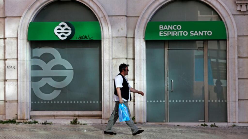 A man walks past an office of Portuguese bank Banco Espirito Santo in Lisbon. Portugal’s central bank has rescued the troubled lender Banco Espirito Santo in a €4.9 billion recapitalisation. Photo: Reuters