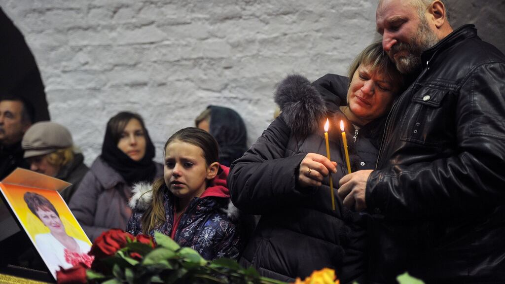 Relatives grieve by the coffin of Nina Lushchenko (60), a victim of the Russian MetroJet Airbus A321 disaster, during a funeral service at a church in Velikiy Novgorod on Thursday. Photograph: Olga Maltseva/AFP/Getty Images