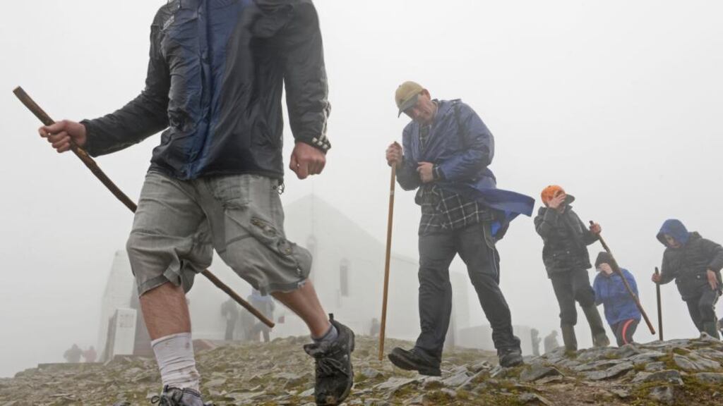 Pilgrims struggle against the weather during the climb to Croagh Patrick on Reek Sunday. Photograph: Dara Mac Dónaill