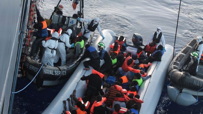Small craft carrying migrants line up beside the LÉ Eithne ahead of winching them aboard. Photograph: Defence Forces