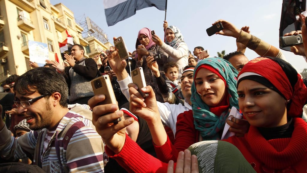 Egyptians use their mobile phones to record celebrations in Cairo’s Tahrir Square, the epicentre of the popular revolt that drove veteran leader Hosni Mubarak from power in 2011. Photograph: Mohammad Abed/AFP/Getty Image