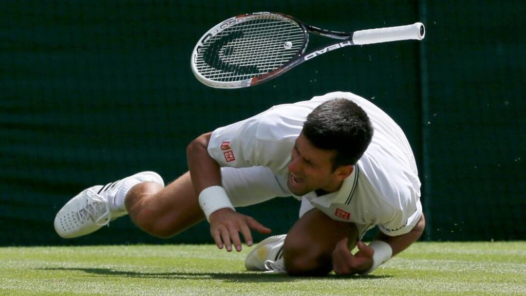Novak Djokovic falls during his men’s singles match against Gilles Simon at the Wimbledon. Photograph: Stefan Wermuth/Reuters