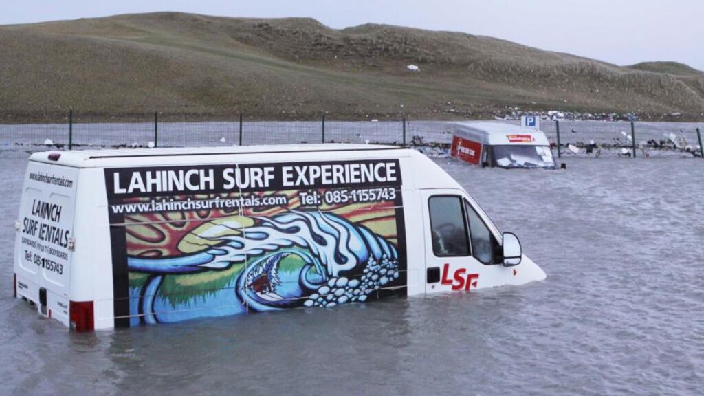 A Lahinch Surf Experience van is submerged in several feet of water at the promenade in Lahinch, Co Clare. Photograph: Press 22