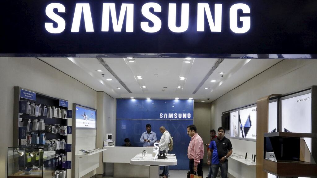 Customers shop at a Samsung mobile store  Photograph:  Anindito Mukherjee/Reuters