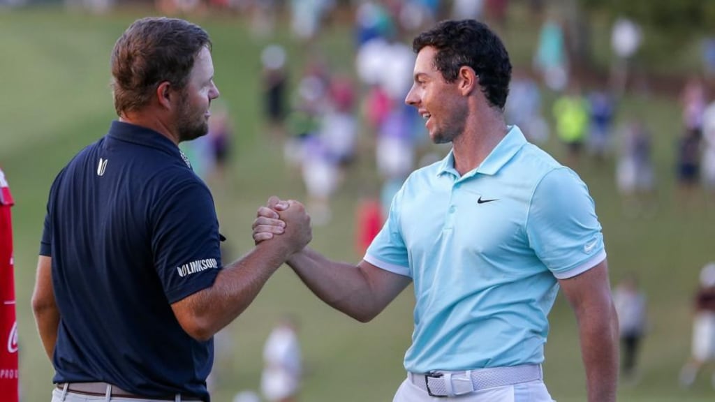 Ryan Moore shakes hands with Rory McIlroy on the 16th green after McIlroy won the Tour Championship on the fourth playoff hole and earned the FedEx Cup at the East Lake Golf Club in Atlanta, Georgia. Photograph: Erik S Lesser/EPA