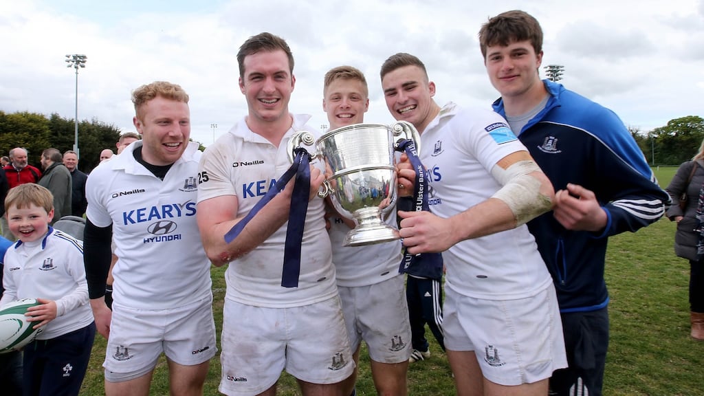 Cork Constitution’s Ned Hobson and teammates with The Bateman Cup. Photograph: Donall Farmer/Inpho