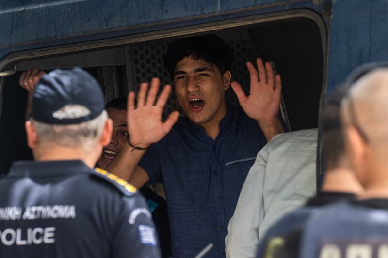 One of the men accused of people smuggling and causing a shipwreck off Greece in June reacts after the court dropped all charges. Photograph: Angelos Tzortzinis/AFP via Getty Images