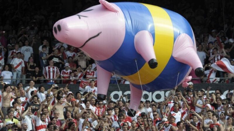River Plate supporters fly an inflatable pig with the colours of Boca Juniors in 2012. Photograph: Juan Mabromata/Getty Images