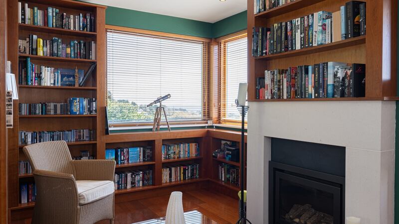 A very cosy dual aspect book-lined study with its own fireplace.