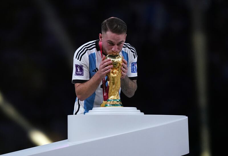 Argentina's Alexis Mac Allister kisses the World Cup trophy. Photograph: Mike Egerton/PA