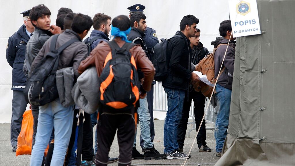 A group of migrants queue to be registered as they prepare to cross the border into Spielfeld in Austria from the village of Sentilj in Slovenia. Photograph: Srdjan Zivulovic/Reuters