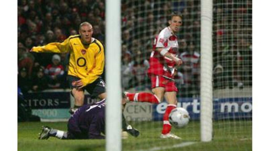 Doncaster Rovers' Michael McIndoe leaves Philippe Senderos and goalkeeper Manuel Almunia floundering as he opens the scoring for Doncaster in last night's League Cup quarter-final at Belle Vue.