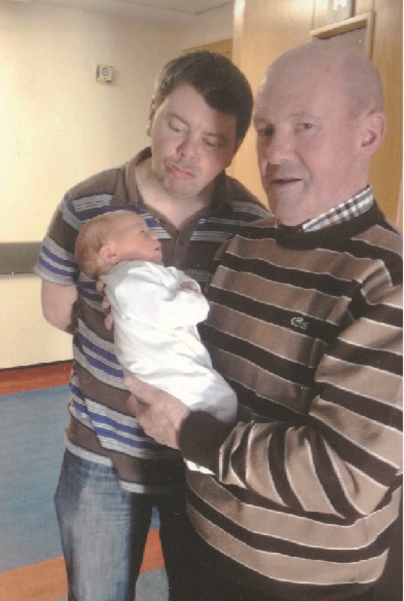 In a photo taken six years ago, Ollie Clerkin holds his new born grand-daughter Cara, as new dad Malachy watches on