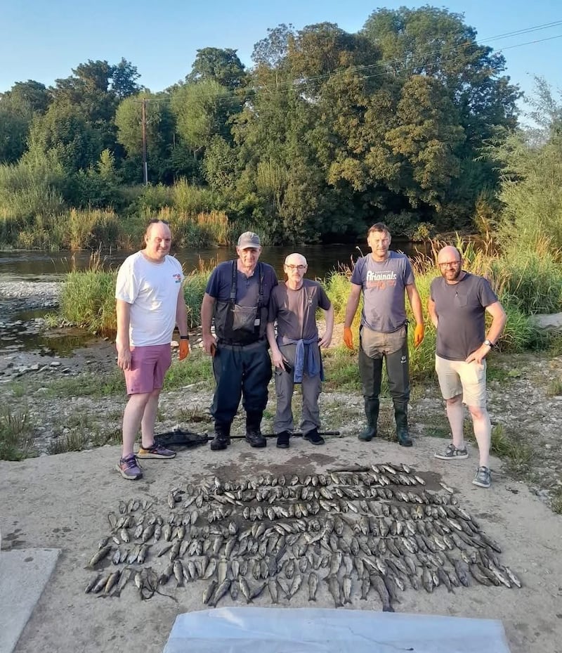 Shane Cummins (left) with other members of Mallow Trout Angler display dead fish they took from the Blackwater in August. Photograph: Barry Roche