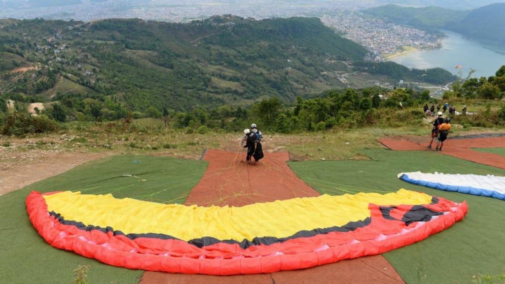 Tourists take part in a paragliding session overlooking Pokhara in Nepal. Photograph: Sajjad Hussain/AFP/Getty Images
