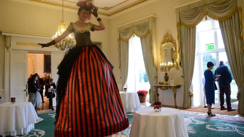 A very tall woman: “A woman on stilts wearing a red-and-black striped dress walked around a room, her head reaching the chandeliers. She was greeted by children who looked at her in wonder.” Photograph: Hajar Akl