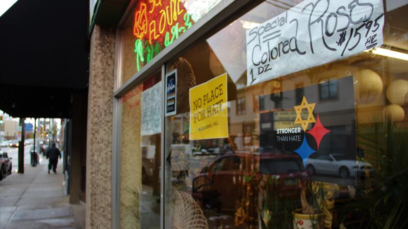 “Stronger than hate” – signs such as this in the window of the Squirrel Hill Flower Shop are common around the neighbourhood. Photograph: Stephen Starr