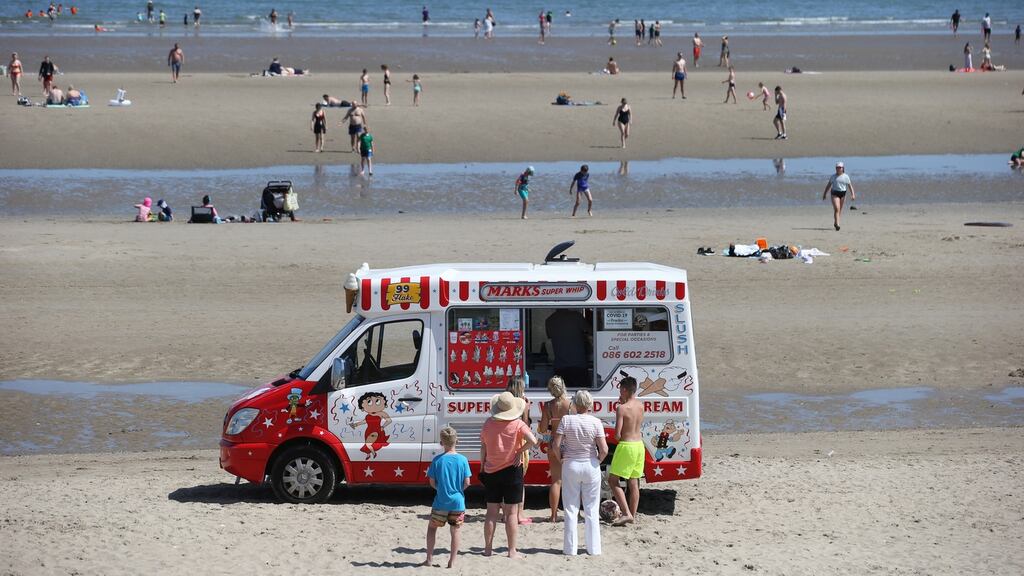 Enjoying the weather at Portmarnock Beech Co Dublin. Met Éireann has issued a rainfall  weather warning for a number of counties this evening. Photograph: Collins