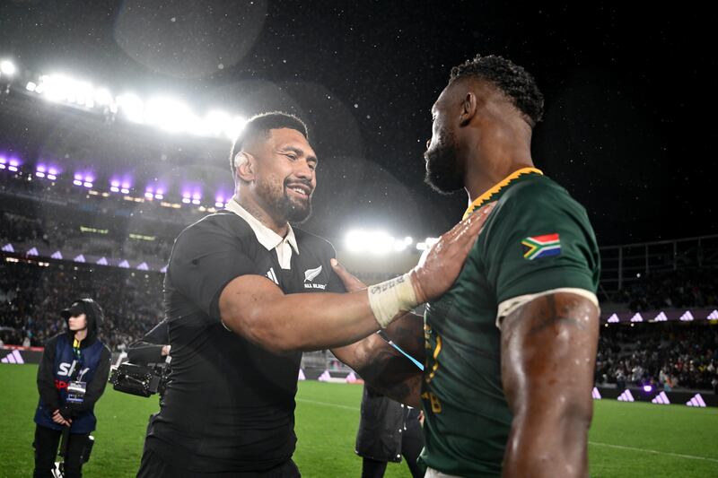 Ardie Savea is congratulated on his 100th cap by South Africa's Siya Kolisi. Photograph: Hannah Peters/Getty Images