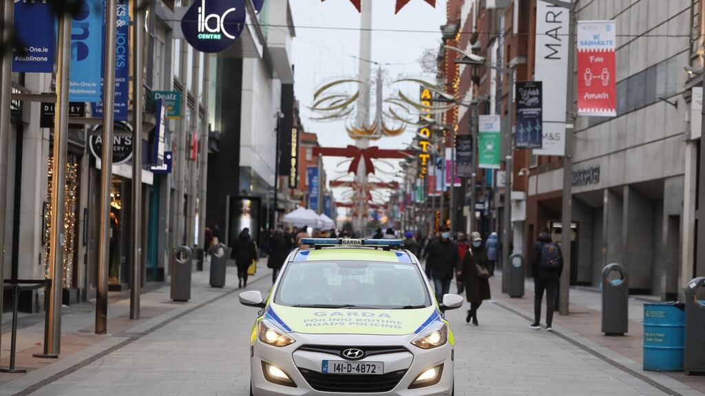 A Garda car on Henry Street in Dublin city centre, where retailers have been asked to defer sales until January. Photograph: Brian Lawless/PA Wire