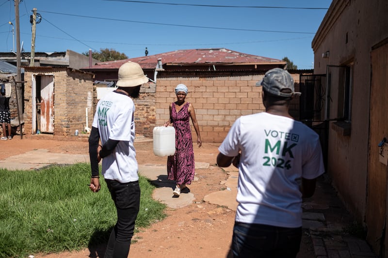 A woman speaks with members of Umkhonto we Sizwe (MK) party in Munsieville near Krugersdorp. Photograph: Emmanuel Croset/AFP via Getty Images