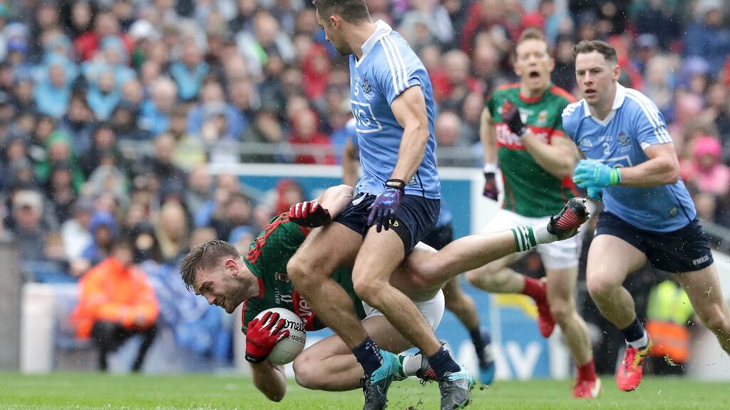 Dublin’s James McCarthy with Aidan O’Shea of Mayo during the All-Ireland Senior Football Championship final at Croke Park. Photo: Morgan Treacy/Inpho