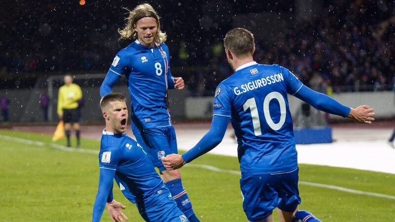 Johann Berg Gudmundsson (L) celebrates with Birkir Bjarnason and Gylfi Sigurdsson after scoring against Kosovo. Photograph: Haraldur Gudjonsson/AFP/Getty