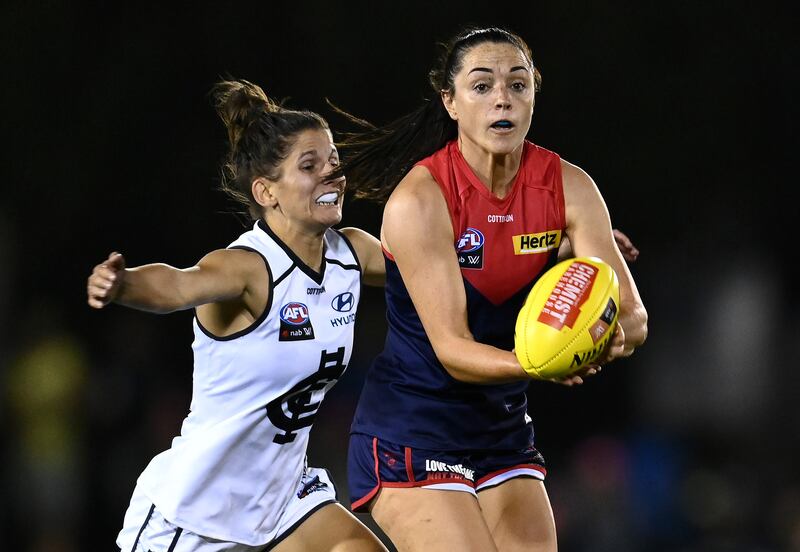Sinead Goldrick of the Demons handballs whilst being tackled during the round 10 AFLW match between the Melbourne Demons and the Carlton Blues at Casey Fields on March 12th. Photograph: Quinn Rooney/Getty Images