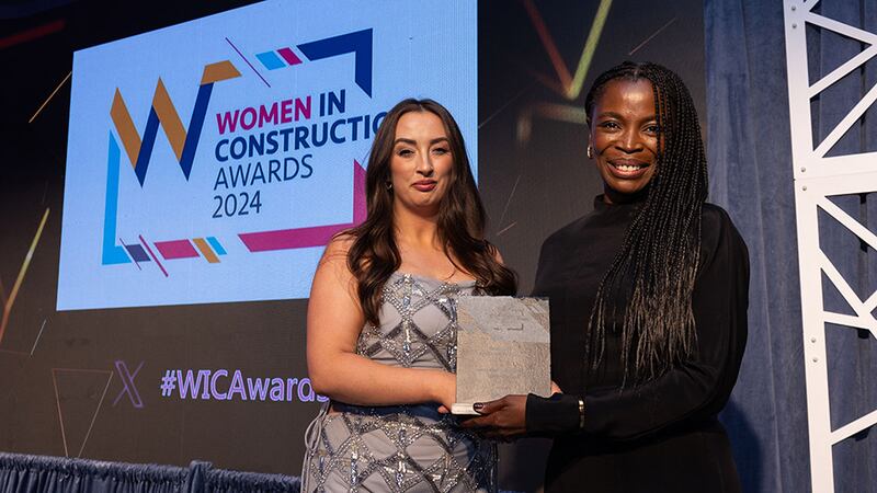 Laura McLoughlin, operations manager, SIG Workplace, presents the excellence in architecture and design award to the Chinwendu Kane, Scott Tallon Architects