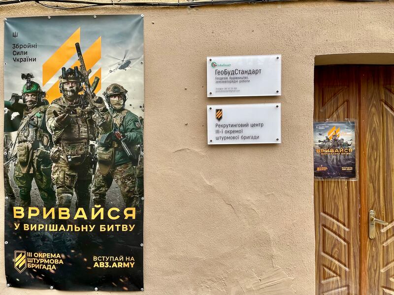 A poster on the wall of a military recruiting office in Lviv, Ukraine, reads: 'Storm into the decisive battle'. Photograph: Daniel McLaughlin
