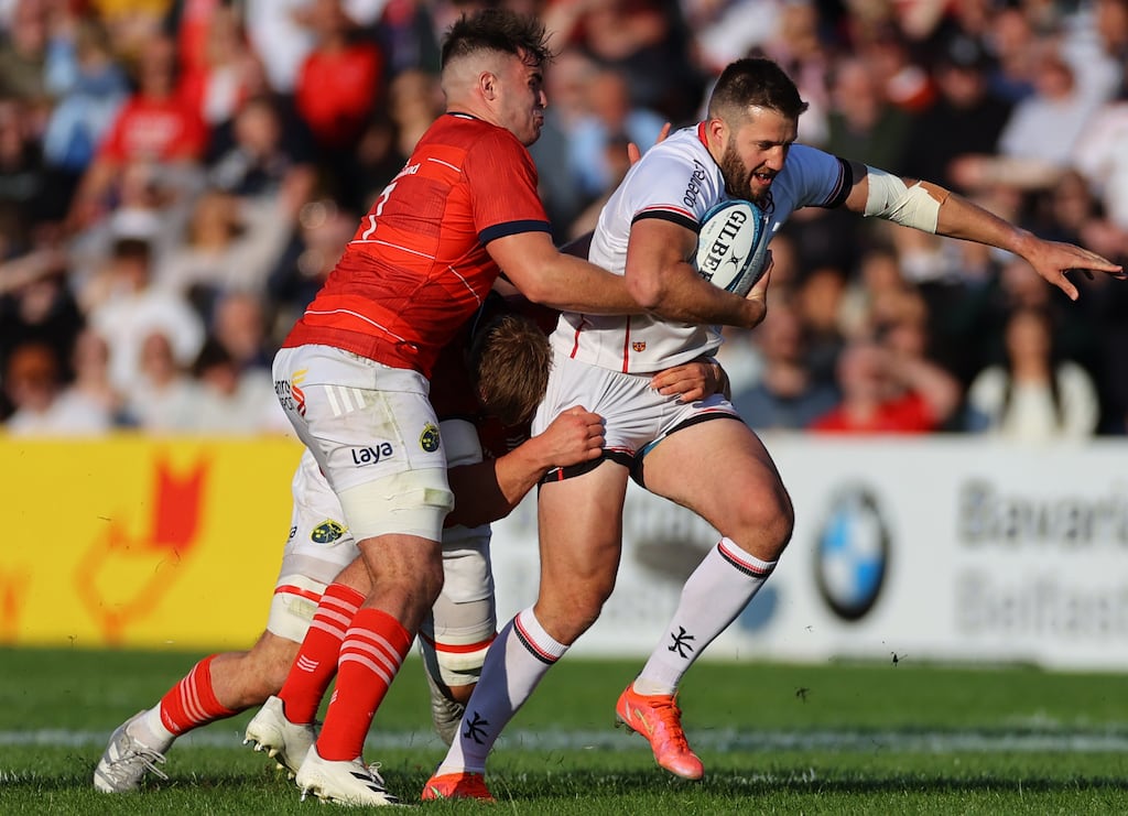 Munster’s Alex Kendellen and Gavin Coombes tackle Ulster centre Stuart McCloskey during Friday's URC quarter-final clash. Photograph: James Crombie/Inpho